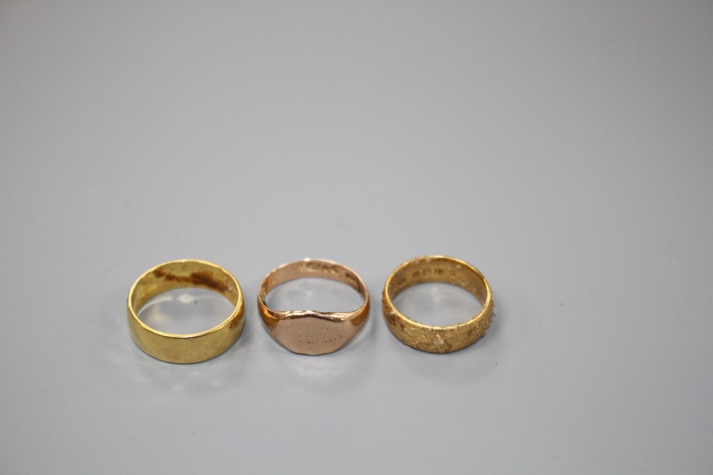 Two 22ct gold wedding bands and a 9ct gold signet ring, 9ct 2.5 grams, 22ct 11 grams.